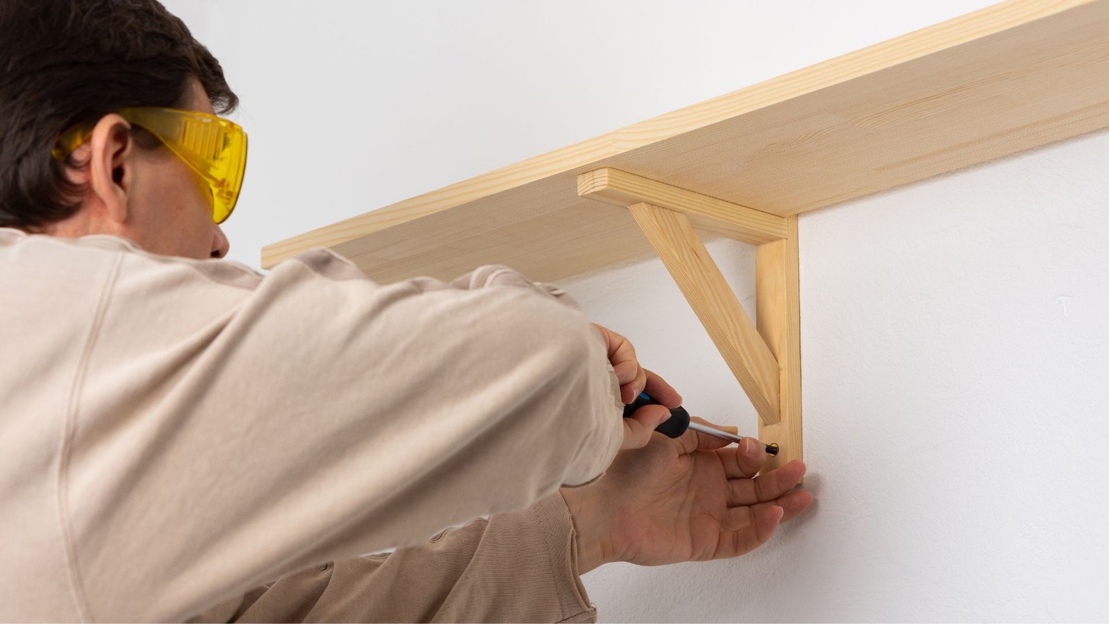 Wall shelf with brackets being installed