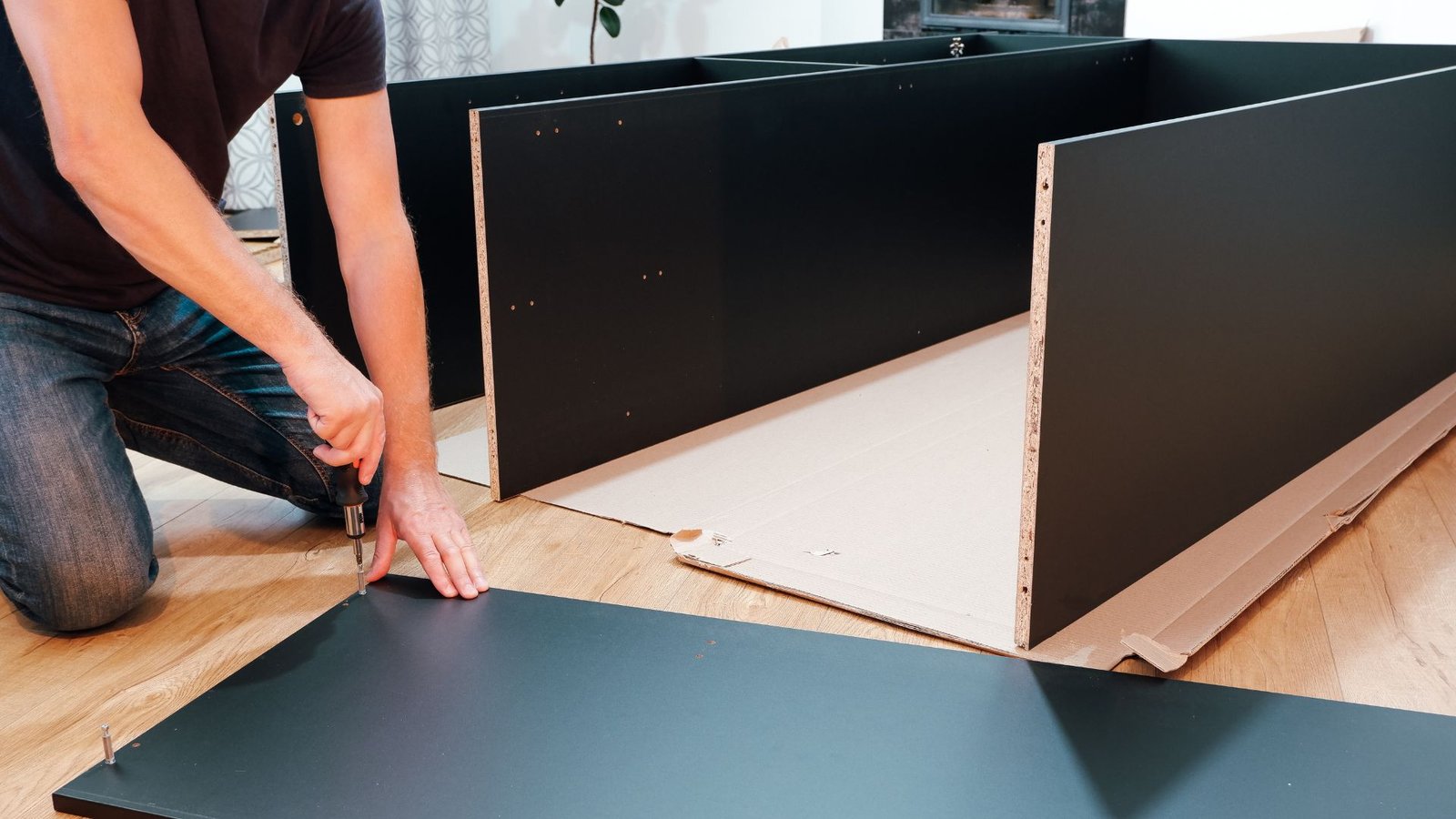 Flat-pack furniture being assembled on the floor